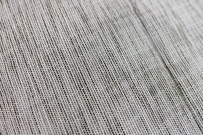 up close detail of woven gray and brown textured bedding