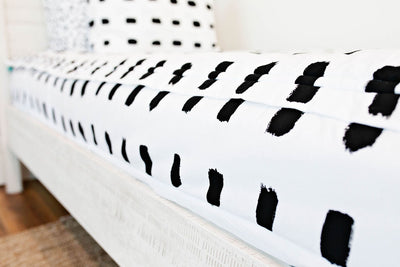 side of white bedding with black dashed lines