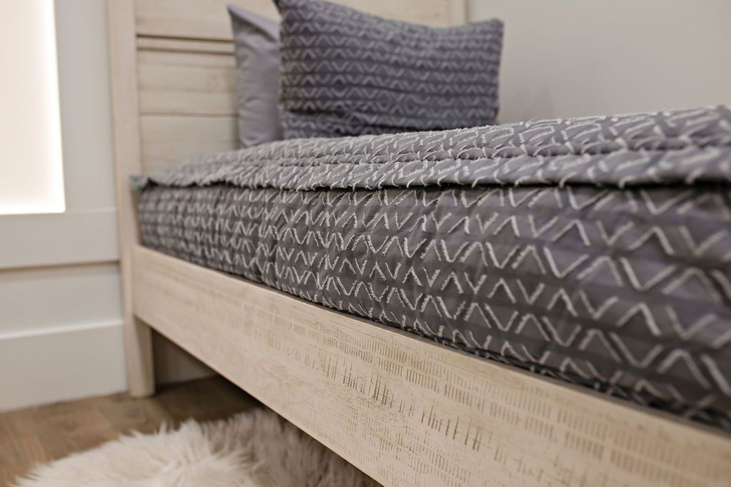 side of Gray bedding with textured diamond design 