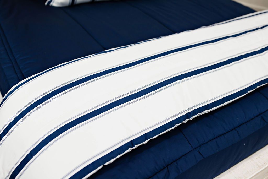 Enlarged view of a white and navy blue striped blanket.