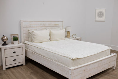Queen bed with cream bedding with textured rectangle design