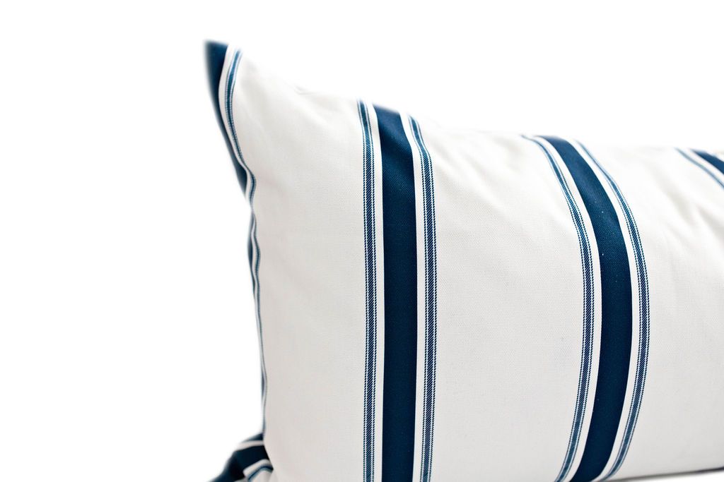 Enlarged view of a white and navy blue striped lumbar pillow.