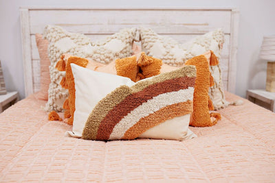 dark cream textured euros, orange, textured pillows with tassels, rainbow lumbar 