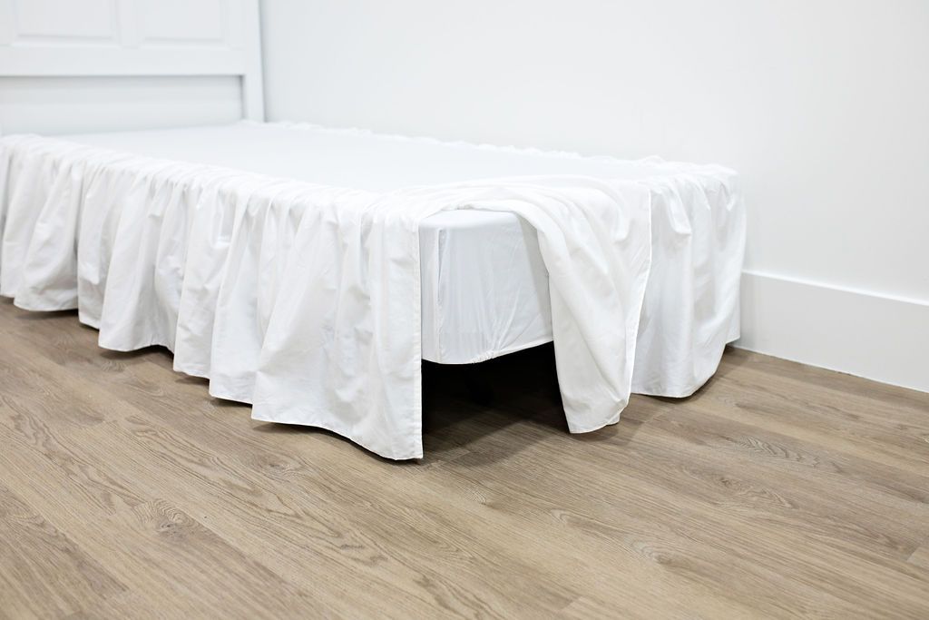 Enlarged view of a white bed skirt.