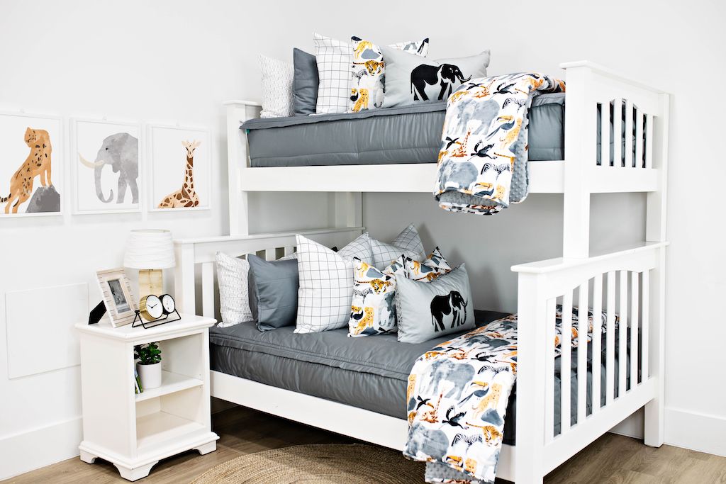 bunk bed with gray zipper bedding and white and black grid patterned euro, safari animal print pillow, gray lumbar with embroidered elephant and safari animal print blanket