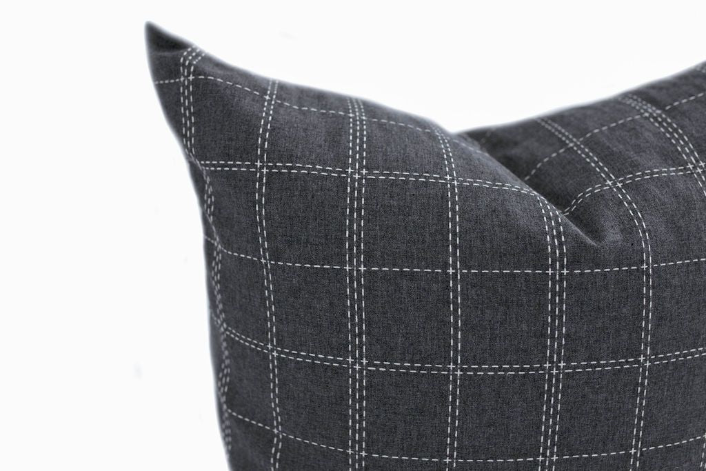 Enlarged view of a blue gray and white plaid pillow.