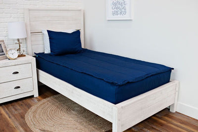 twin bed with navy blue zipper bedding