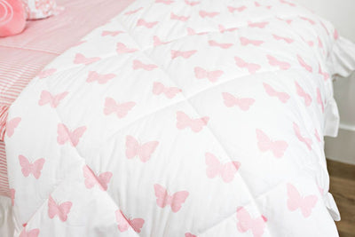 Enlarged view of a white and pink butterfly blanket.
