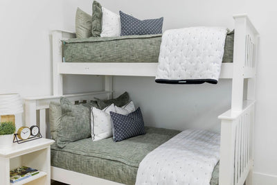 Bunk bed with Green zipper bedding with matching pillowcases and shams. Decorated with white and gray pillows and white blanket
