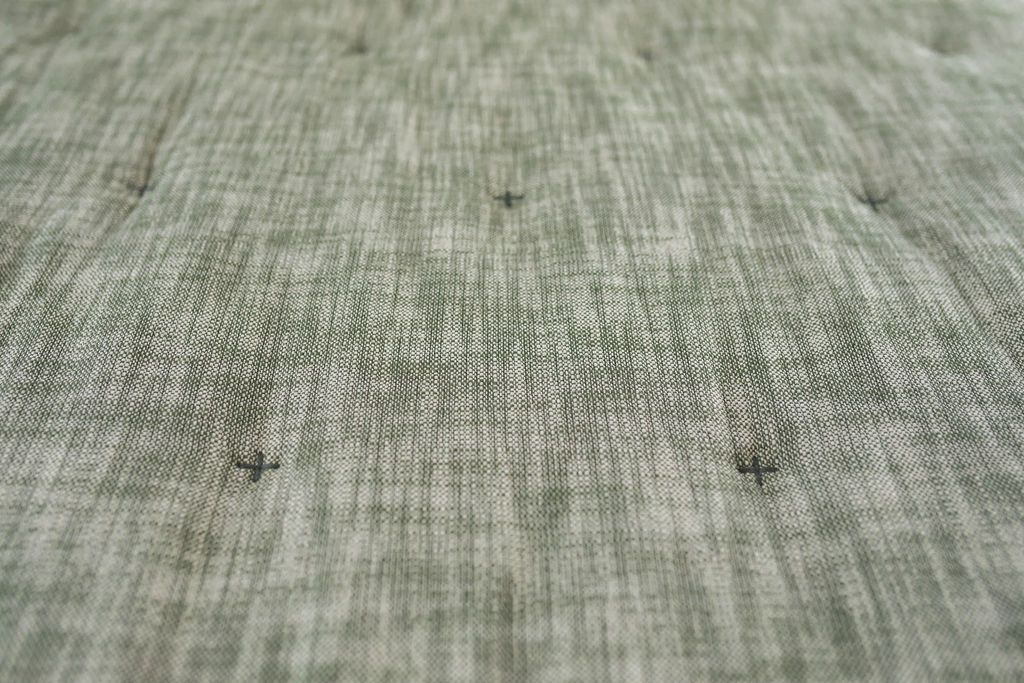 Up close view of Green zipper bedding 