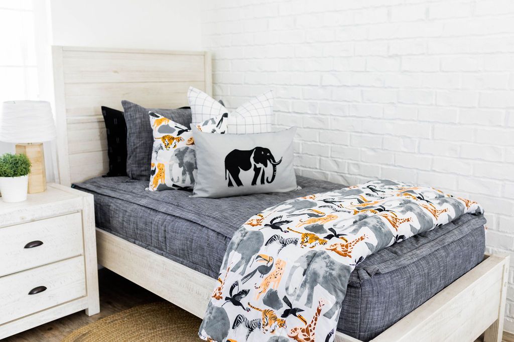 Dark gray charcoal zipper bedding with matching sham and black pillow cases. Decorated with jungle graphic pillows and blanket