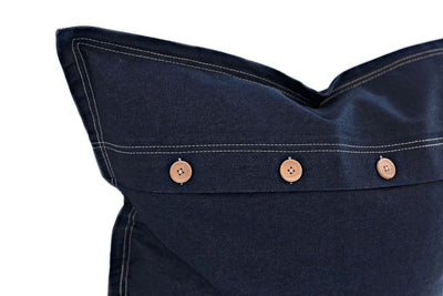Corner of blue denim euro with buttons