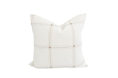 A white medium pillow with a cream plaid embroidery design.