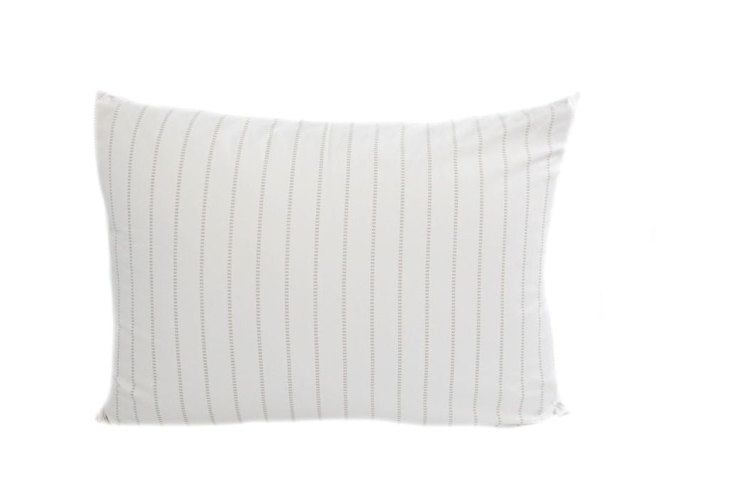 A white pillowcase with a striped pattern design.
