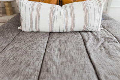 Brown and gray woven textured bedding with faux leather pillow, cream striped XL lumbar