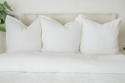 White duvet and matching pillows on bed