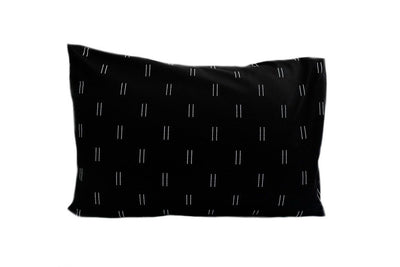 A black pillowcase with a two white line repeated pattern.