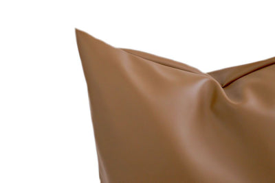 Close up of brown faux leather pillow