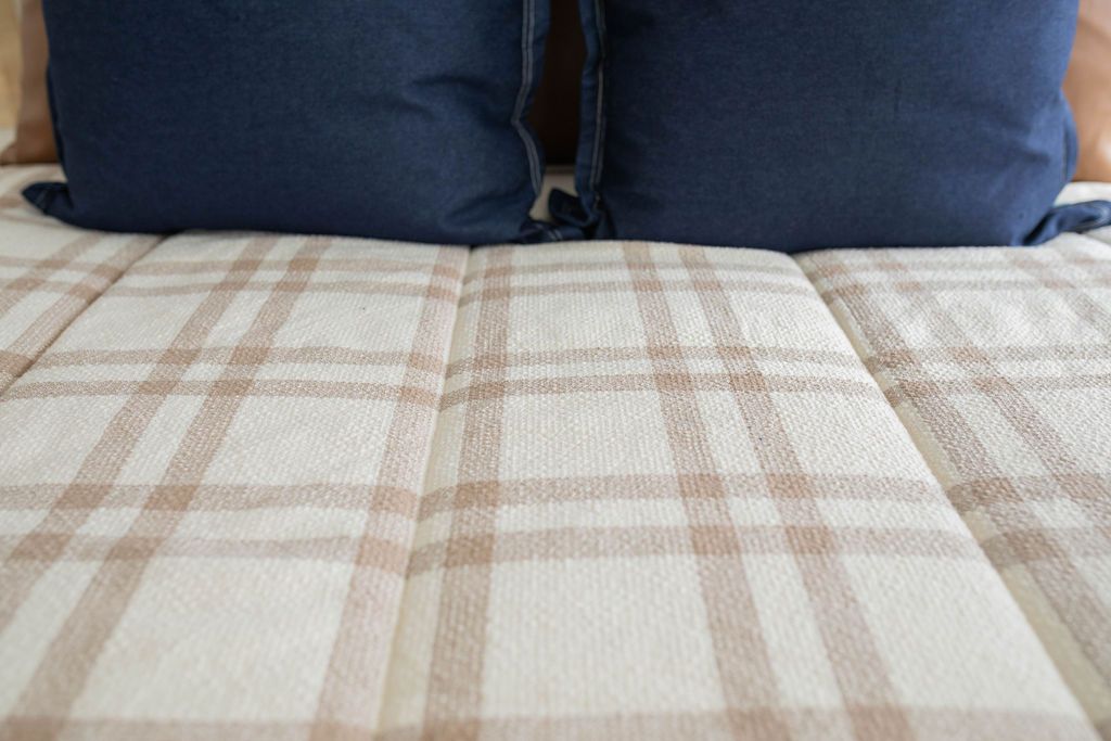 Cream and brown plaid zipper bedding with blue pillow shams