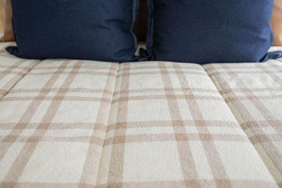 Cream and brown plaid zipper bedding with blue pillow shams