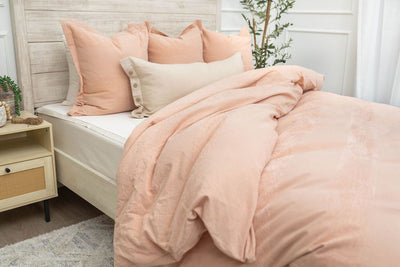 Pink euro pillow cover with pink duvet bedding on bed