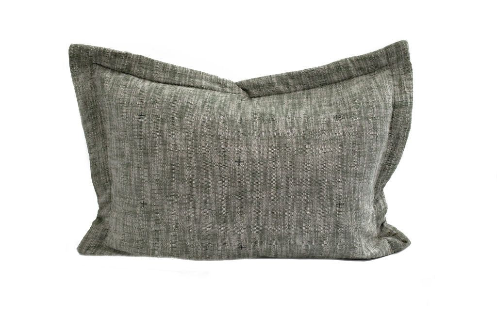 A dark green pillow sham with a small stitch design.