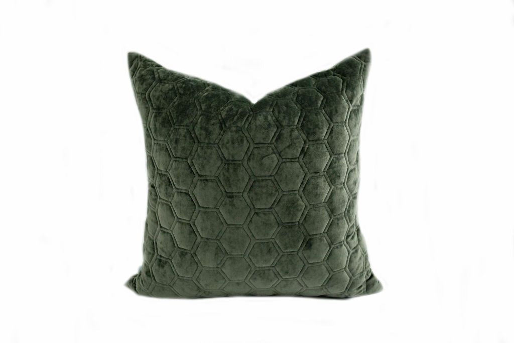 An emerald honeycomb quilted velvet pillow on a white background.