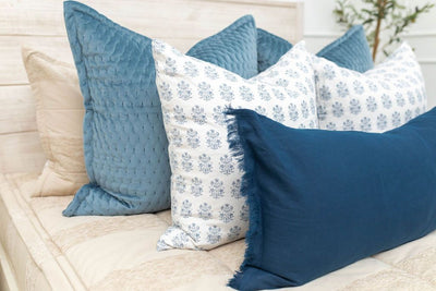 Tan zipper bedding with tan, blue and white pillows