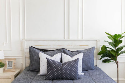 Gray charcoal zipper bedding with gray, black and white pillows 